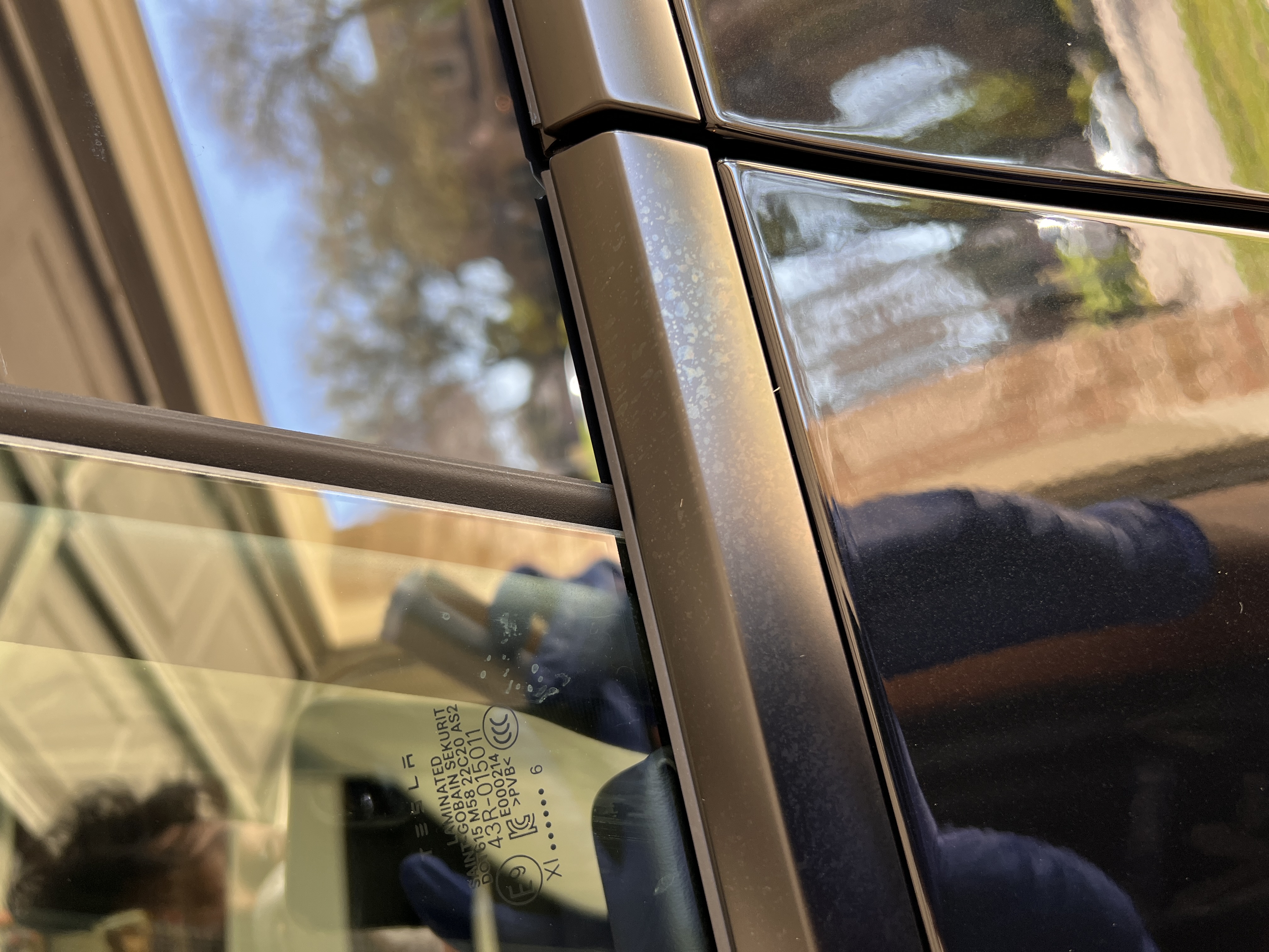 Vehicle window trim with oxidation and spotting before restoration